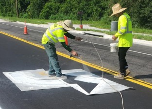 Painting turn arrows on Prospect Road at CR 52 (7-28-2023 photo)