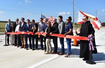 State and local government officials cut a ribbon on new SR 52 marking the opening of the realigned roadway (2/17/2023 photo)