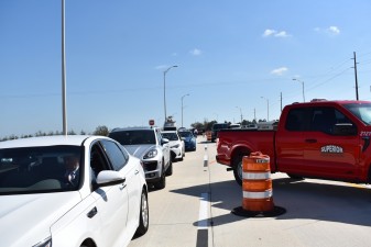 A procession of vehicles drives on the new westbound SR 52 for the first time (2/17/2023 photo)