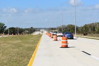 A procession of vehicles drives on the new westbound SR 52 for the first time (2/17/2023 photo)