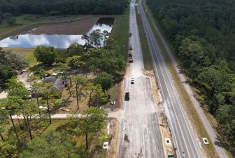 Looking east over SR 50 at a new storm water drainage pond and westbound roadway construction (4-29-2025 photo)