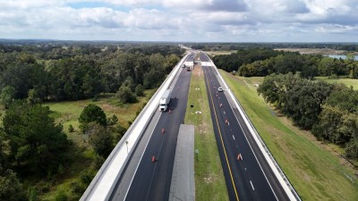 Traffic is now one lane in each direction and separated by the median as final paving takes place (10-28-2025 photo)