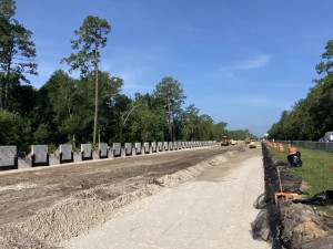 Construction of permanent retaining wall on the left and temporary retaining wall on the right along SR 50 (6/16/2022 photo)
