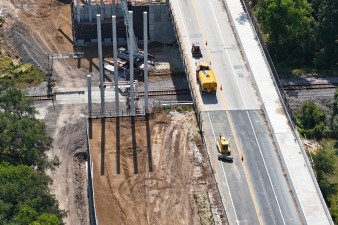 Looking southeast over SR 50 at construction of a new bridge for westbound traffic (4-29-2025 photo)