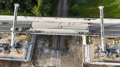 Beam one for the westbound SR 50 bridge is lifted off the transport truck (8-23-2025 photo @ 8:09 a.m.)