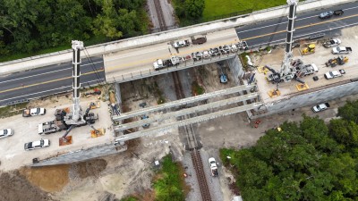 The third bridge beam for the westbound SR 50 bridge is set into place (8-23-2025 photo @ 1:47 p.m.)