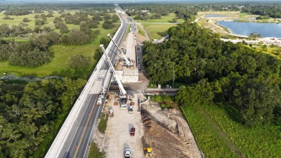 Cranes are hooking up to the first bridge beam that will be set for the westbound SR 50 bridge (8-23-2025 photo @ 8:07 a.m.)