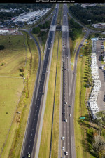 On the left side of this December 2019 photo, the  final layer of paving (dark black pavement) has been placed in two of the three mainline travel lanes