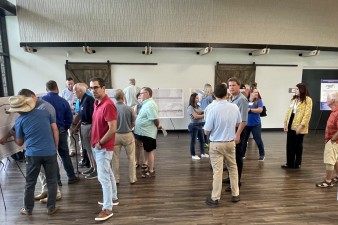 Visitors talk with project team members and view project plans during a public open house for the project (9/10/2024 photo)