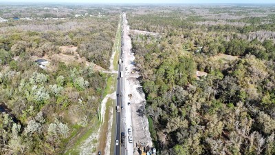 Looking NW over US 98 at traffic shifted to temporary pavement between W Socrum Loop Rd. and Big Cypress Blvd. (3-4-2025 photo)