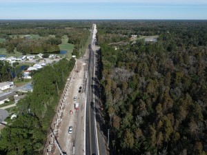 Looking northwest over US 98 at noise barrier construction on the left and new pavement on the right (11-11-2025 photo)