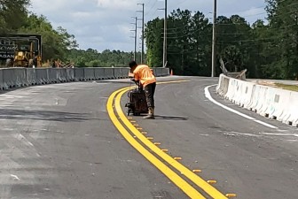 Installing pavement markings to a temporary roadway where US 41 traffic will be shifted east of the existing alignment (5/10/2021 photo)