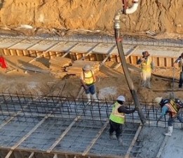 Placing concrete for footers that will support the underpass segments (6/11/2021 photo)