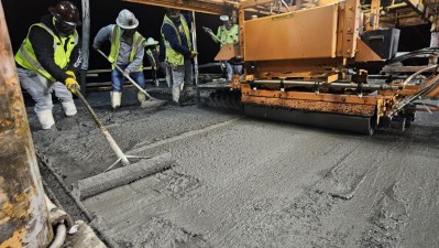 Crews work to smooth concrete on the deck span (April 2026 photo)