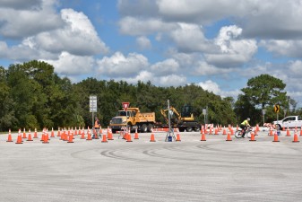 FDOT staff test different size vehicles and a bicycle through the test-track roundabout (10/13/2021 photo)