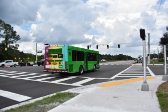 A bus travels south on Bruce B. Downs Blvd. through the new signalized intersection at Eagleston Blvd. (5-22-2023 photo)