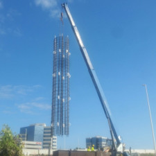 Lowering a reinforcing steel cage into a drilled shaft prior to placing concrete in the shaft