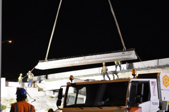 Crews place a concrete beam over SR 60 where the northbound I-275 bridge is being widened (3/20/2020 photo)