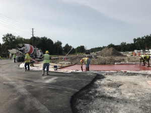 Looking south on US 98 at the US 98/Trilby intersection. Crews are working on placing red-colored concrete. (June 25, 2020 photo)