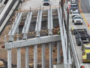 Setting a concrete I-beam for a new US 98 bridge over the railroad tracks (5-12-2026 photo)