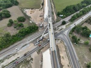 Setting a concrete I-beam for a new US 98 bridge over the railroad tracks next to Old Lakeland Highway (5-12-2026 photo)