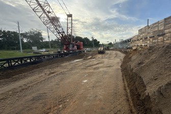 Installing temporary wall for new bridge construction over Old Lakeland Highway and the railroad tracks (9-8-2025 photo)