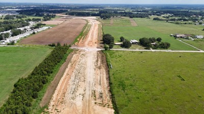 Looking north over construction of the new US 98 alignment at the Wilds Road intersection (8-30-2025 photo)