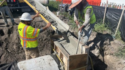 Placing concrete for concrete jacket-collar for storm drainage (July 2026 photo)