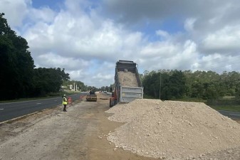 Unloading embankment material in the median of US 98 / SR 50 for temporary pavement construction (5-27-2026 photo)