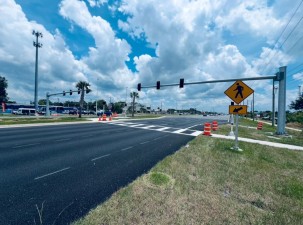 Looking southeast across US 19 at a new mid-block crossing that is expected to open in July north of SR 52 (5/31/2025 photo)
