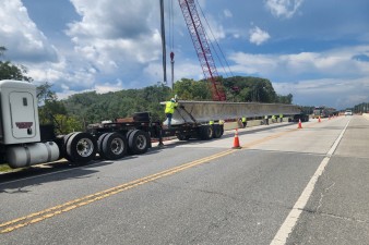 Preparing to lift a bridge beam from the transport truck to its position next to US 301 (8-17-2026 photo)