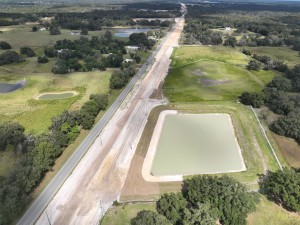 Looking north over US 301 at storm water pond and roadway construction north of Trilby Rd. / SR 575 (10-15-2025 photo)