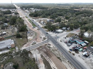 Looking southwest over US 301 at roadway widening and roundabout construction at SR 575 / Trilby Road (1-13-2026 photo)