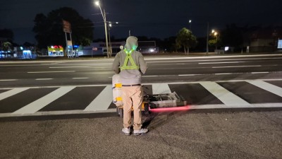 Crews install crosswalk pavement markings (April 2026 photo)