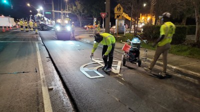 Crews install right turn arrow pavement marking on East Bay Drive (February 2026 photo)