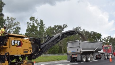 Milling operations are underway to remove existing asphalt between the westbound travel lanes and turn lane (7-21-2025 photo)