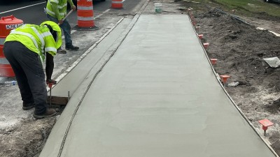 Image of new concrete curb work and sidewalk on County Line Road looking south (Photo June 2026)