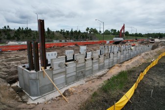 Building the retaining wall panel by panel for the trail bridge approach (4-9-2026 photo)
