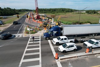 Looking south at a Suncoast Trail bicyclist crossing busy SR 52 (6-10-2026 photo)
