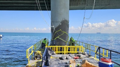 Crews work from floating platform to perform maintenance on the Sunshine Skyway Bridge (May 2026)