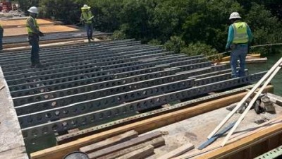 Crews install decking shims (May 2026 photo)