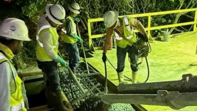 Crews pour concrete (May 2026 photo)