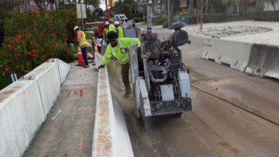 Crews sawcut existing deck (March 2026 photo)