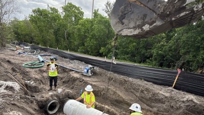 Excavator places drainage structure (June 2026 photo)