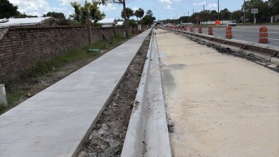 Looking west at Curlew Road at completed 6 foot sidewalk and Curb (August 2026 photo)