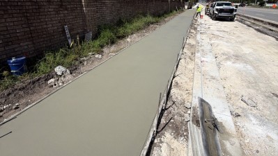 Looking west at concrete being placed and finished on 6 foot sidewalk along Curlew Road (August 2026 photo)