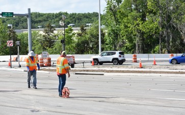 Workers place marks for roadway restriping (5/1/2022 photo)